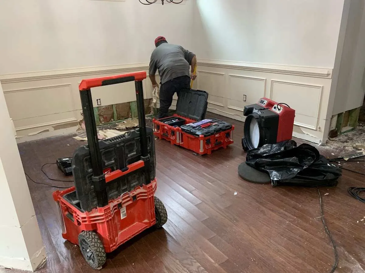 Technician setting up drying equipment for water damage in Brookfield